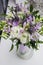 Modern bride bouquet white, violet, green flowers. Rustic wedding style of beautiful buttercup ranunculus, fresia