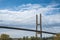 Modern bridge pylon against blue sky. Multi-span cable-stayed bridge. White cable-stayed suspension Alex Fraser Bridge