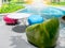 Modern bright colors chairs and a variety of shapes and round tables beside the outdoor swimming pool