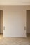 Modern and bright interior of empty cream-colored room with herringbone parquet floor