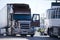 Modern brown big rig semi truck with open door and reefer trailer on truck stop