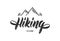 Modern brush lettering of Hiking Club with mountains.
