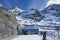 Modern building against majestic snow covered mountains