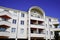 Modern building apartment complex white wall blue sky