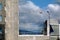 modern building and dynamic blue sky with white clouds. blurry green mountain