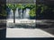 Modern building and empty courtyard with bench and lonely tree