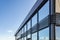 Modern building with glass windows against a blue sky