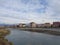 Modern buildings on river embankment, low-flying aircraft, Adler, Russia