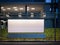 Modern bus stop with horisontal blank billboard at night. 3d rendering