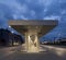 Modern bus stop shelter in Mendrisio. There is a long, lighted corridor with several stops