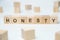 Modern business buzzword - honesty. Word on wooden blocks on a white background