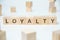 Modern business buzzword - loyalty. Word on wooden blocks on a white background