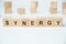 Modern business buzzword - synergy. Word on wooden blocks on a white background