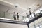 Modern business people walking on stairs in glass hall in office