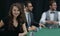 Modern business woman sitting at craps table in a casino.