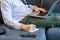 Modern businessmen lie down on lobby couch for casual relaxation by stretching legs and working with comfortable laptops for