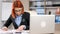 Modern businesswoman in formal suit working at her desk