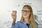 The modern businesswoman. a young businesswoman plotting out a plan with with a marker on a glass wall in her office.