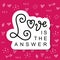 Modern calligraphy lettering of Love is the answer in black with white outline on pink background