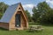 Modern camping pods and table in a field.