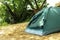 Modern camping tent in forest