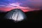 Modern camping tent glowing in twilight