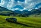 Modern car on a green hill in a picturesque mountains valley