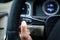 Modern car interior - driver pressing a button