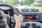 Modern car interior: Male hands on a sports car steering wheel