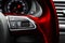 Modern car interior. Red Steering wheel with media phone control buttons, navigation multimedia system background. Car interior de