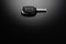 Modern car keys isolated on black reflective background