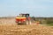 Modern case tractor drilling seed in field