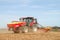 Modern case tractor drilling seed in field