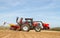 Modern case tractor drilling seed in field