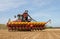 Modern case tractor drilling seed in field