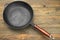 Modern Cast Iron Non-Stick Frying Pan On The Wood Table