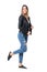 Modern casual beauty in jeans and leather jacket posing with raised up leg