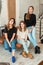 Modern casual women on sofa Group of young stylish women looking at camera in modern interior