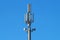 Modern Cellular Tower - Communication on Blue Sky. Vertical Photography.