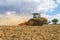 Modern Challenger tractor cultivating English crop field