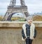 Modern child standing against Eiffel tower in Paris, France