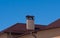 Modern chimney on the roof of the mansion in the sunlight.