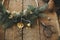 Modern christmas wreath with bells, fir branches, pine cones, scissors on rustic table. Atmospheric moody image. Merry Christmas