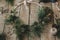 Modern christmas wreath with spruce branches, herbs, scissors,candle, pine cones on rustic wood. Moody image. Merry Christmas!