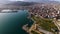 Modern city architecture on seashore with spectacular mountains, aerial view