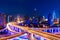 Modern city skyline with interchange overpass at night