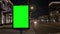 Modern citylight box with green empty screen at night