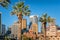 Modern cityscape skyline with skyscrapers and historic buildings with palm trees