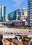 Modern cityscape with underground train terminal, on a sunny day.