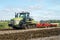 Modern claas tractor cultivating field